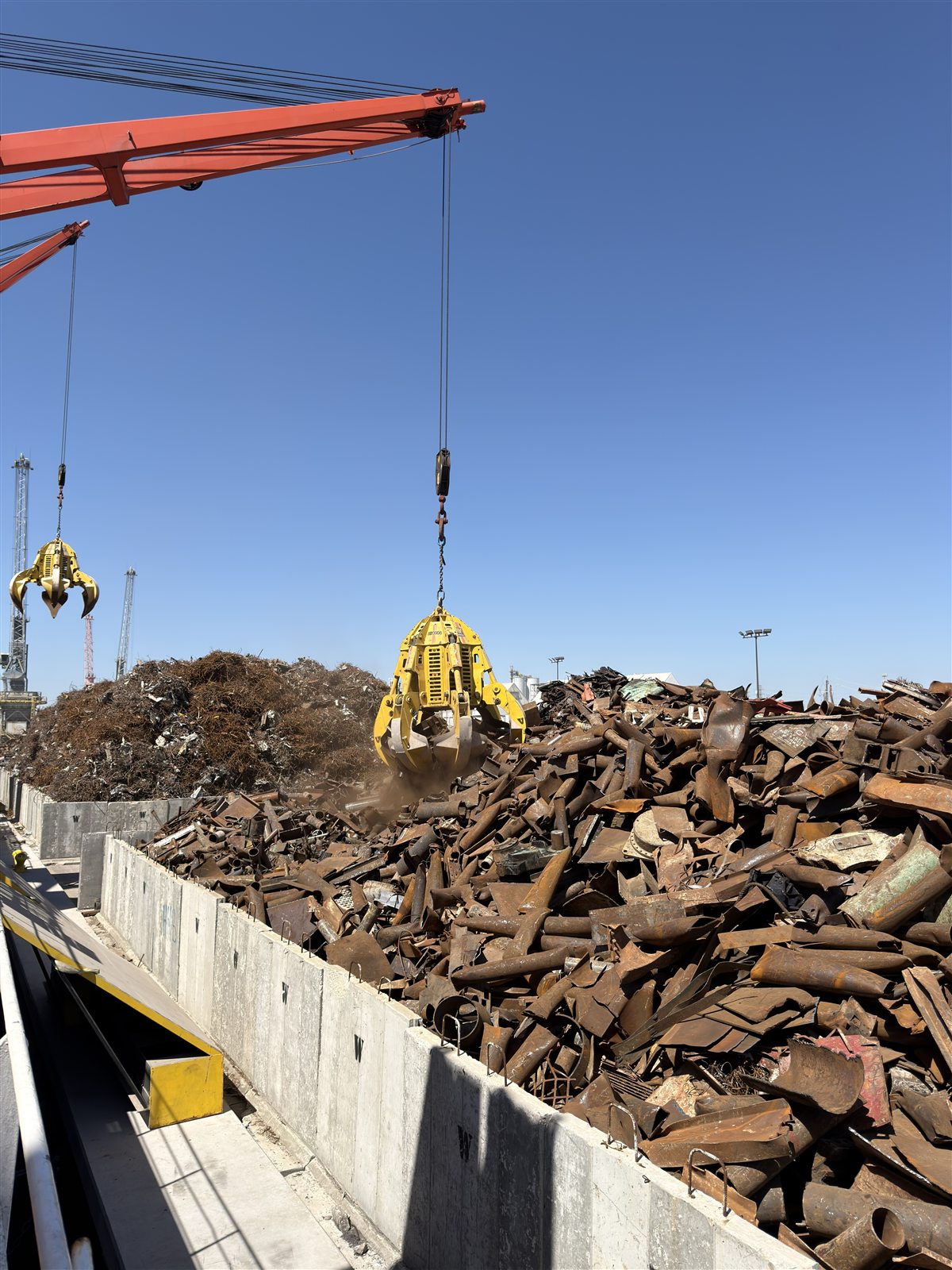Grapple crane loading ferrous scrap into the Gold Star Metals terminal bunker