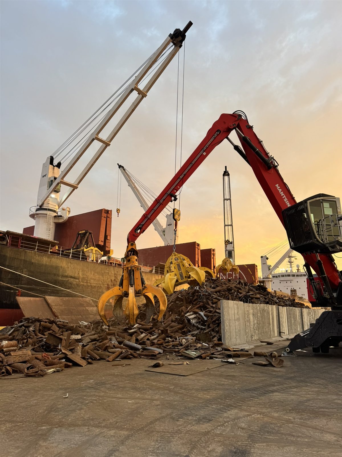 Gold Star Metals loading scrap onto a bulk export vessel at sunset